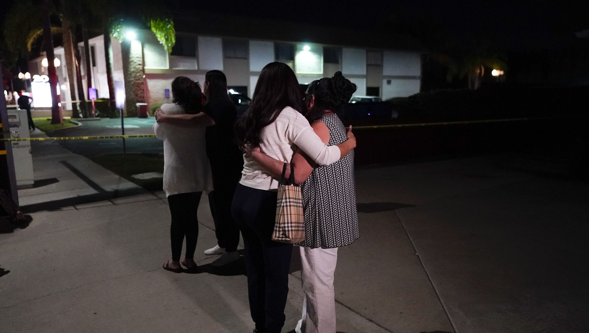 Unidentified people comfort each other as they stand near a business building where a shooting occurred in Orange, Calif., Wednesday, March 31, 2021 Unidentified people comfort each other as they stand near a business building where a shooting occurred in Orange, Calif., Wednesday, March 31, 2021 - Sputnik International, 1920, 01.04.2021