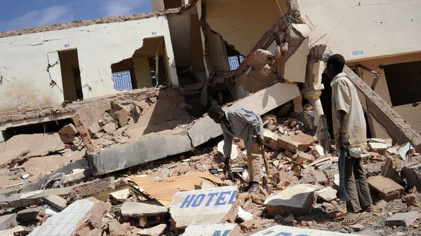 In this file photo children search on February 5, 2013 in the ruins of a hotel destroyed by French air strikes in  Douentza, as he town was retaken by French and Malian troops in January. - Sputnik International