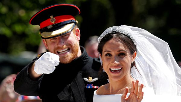 Britain’s Prince Harry gestures next to his wife Meghan as they ride a horse-drawn carriage after their wedding ceremony at St George’s Chapel in Windsor Castle in Windsor, Britain, May 19, 2018. - Sputnik International