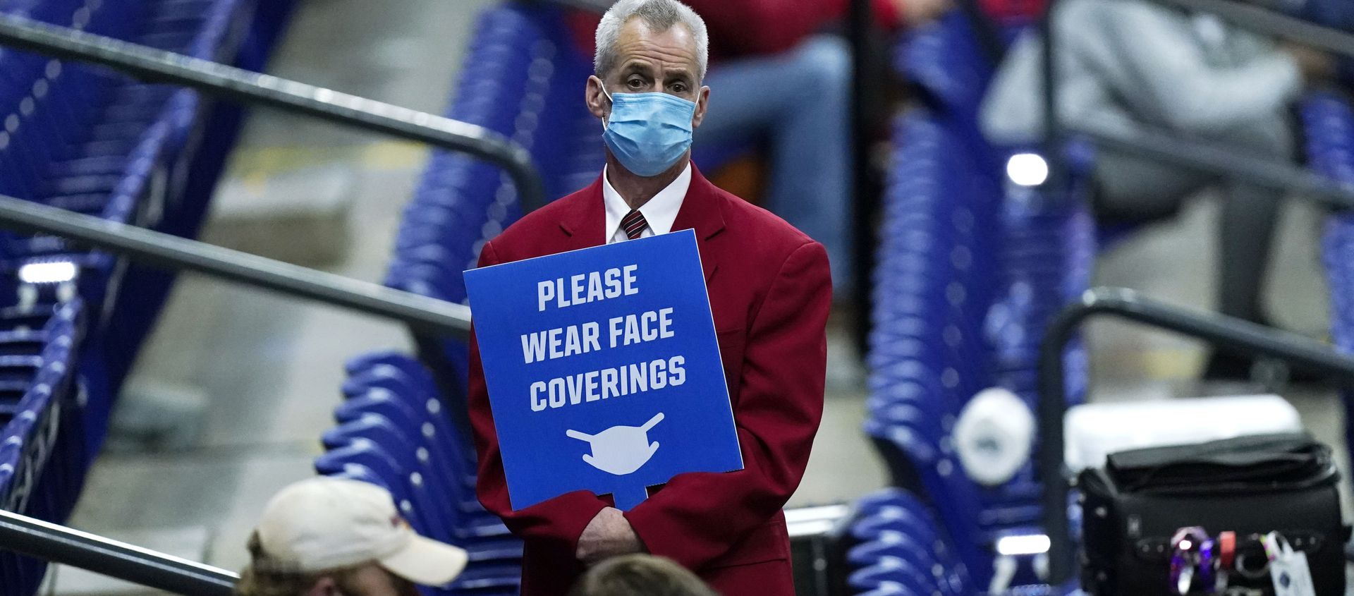 In this March 21, 2021, file photo, an usher holds a sign reminding fans to wear masks during a college basketball game between Houston and Rutgers in the second round of the NCAA tournament at Lucas Oil Stadium in Indianapolis In this March 21, 2021, file photo, an usher holds a sign reminding fans to wear masks during a college basketball game between Houston and Rutgers in the second round of the NCAA tournament at Lucas Oil Stadium in Indianapolis - Sputnik International, 1920, 02.04.2021