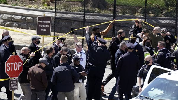 Police officers gather near a car that crashed into a barrier on Capitol Hill in Washington, Friday, April 2, 2021.  - Sputnik International