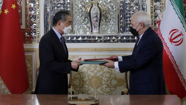 Iranian Foreign Minister Mohammad Javad Zarif (R) and his Chinese counterpart Wang Yi, are pictured during the signing of an agreement in the capital Tehran, on March 27, 2021. Iranian Foreign Minister Mohammad Javad Zarif (R) and his Chinese counterpart Wang Yi, are pictured during the signing of an agreement in the capital Tehran, on March 27, 2021. - Sputnik International
