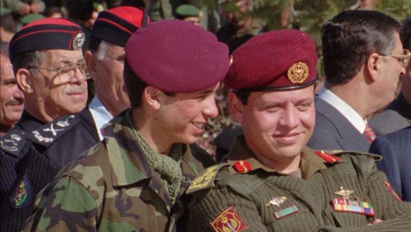 Jordan's Prince Hamza, 19, left, whispers in the ears of his elder brother, Prince Abdullah, 37, in this June 1998 photo taken during a military parade in Jordan.  - Sputnik International