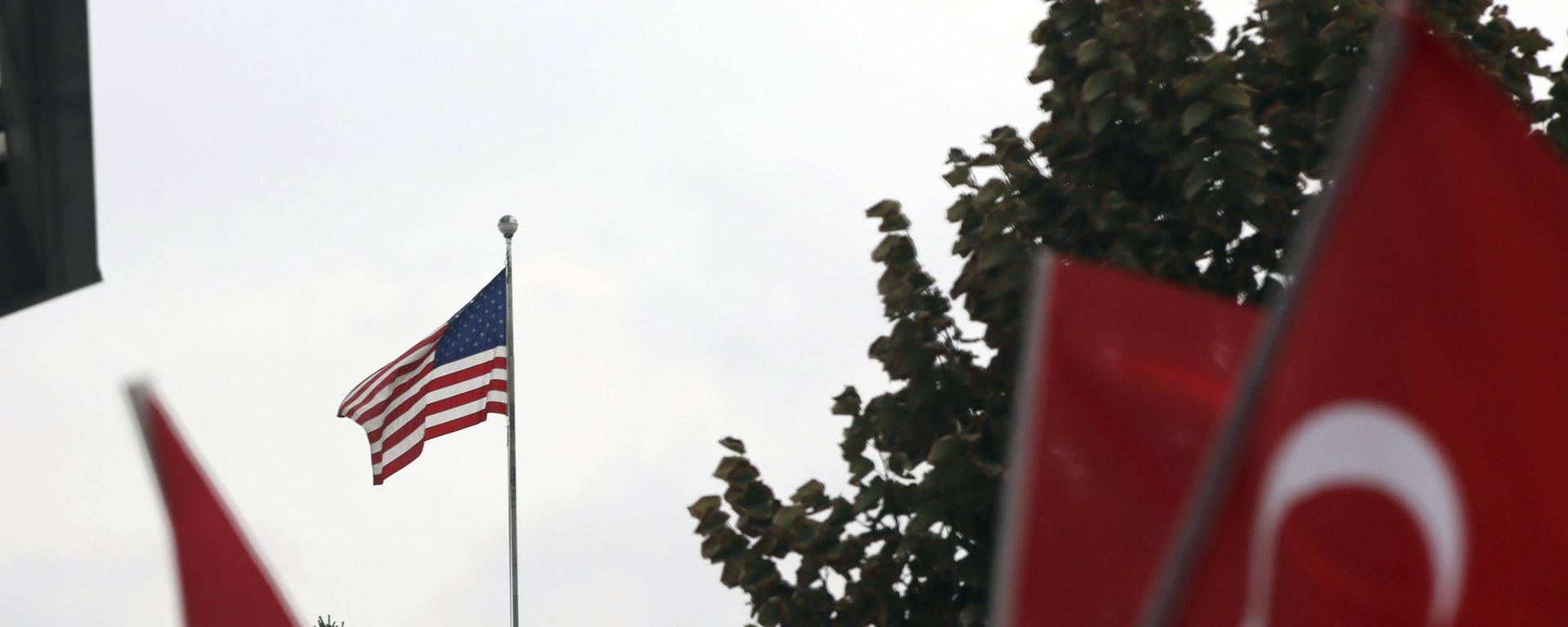 Members of a Turkish political party hold national flags during a protest near the U.S. embassy in Ankara, Turkey, Tuesday, Oct. 8, 2019. Turkey's vice president Fuat Oktay says his country won't bow to threats in an apparent response to U.S. President Donald Trump's warning to Ankara about the scope of its planned military incursion into Syria. Members of a Turkish political party hold national flags during a protest near the U.S. embassy in Ankara, Turkey, Tuesday, Oct. 8, 2019. Turkey's vice president Fuat Oktay says his country won't bow to threats in an apparent response to U.S. President Donald Trump's warning to Ankara about the scope of its planned military incursion into Syria. - Sputnik International, 1920, 26.10.2021