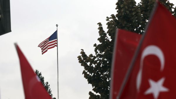 Members of a Turkish political party hold national flags during a protest near the U.S. embassy in Ankara, Turkey, Tuesday, Oct. 8, 2019. Turkey's vice president Fuat Oktay says his country won't bow to threats in an apparent response to U.S. President Donald Trump's warning to Ankara about the scope of its planned military incursion into Syria. Members of a Turkish political party hold national flags during a protest near the U.S. embassy in Ankara, Turkey, Tuesday, Oct. 8, 2019. Turkey's vice president Fuat Oktay says his country won't bow to threats in an apparent response to U.S. President Donald Trump's warning to Ankara about the scope of its planned military incursion into Syria. - Sputnik International