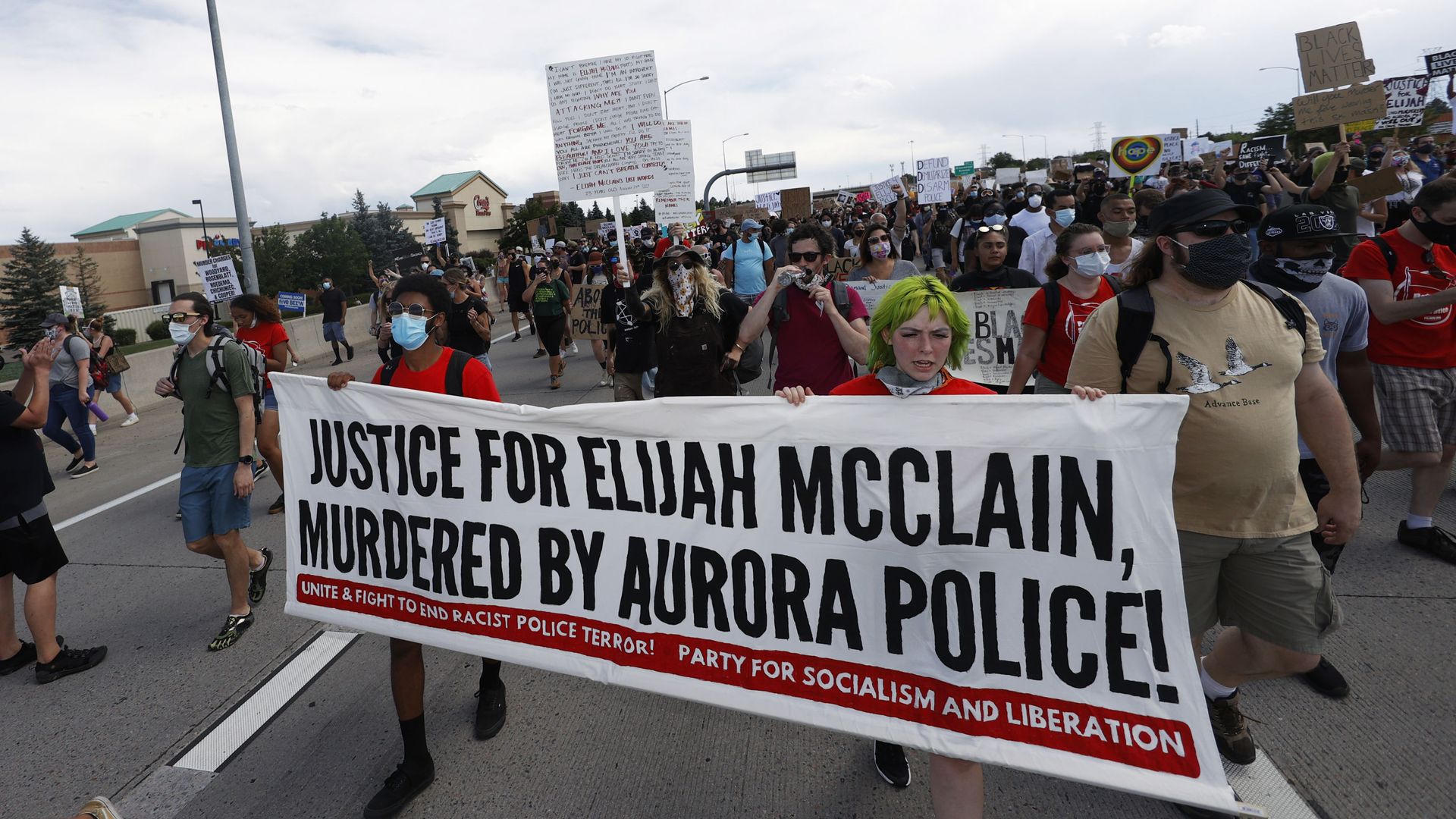 Demonstrators carry a banner while marching down Interstate 225 during a rally and march over the death of 23-year-old Elijah McClain, Saturday, June 27, 2020, in Aurora, Colo. McClain died in late August 2019 after he was stopped while walking to his apartment by three Aurora Police Department officers. Demonstrators carry a banner while marching down Interstate 225 during a rally and march over the death of 23-year-old Elijah McClain, Saturday, June 27, 2020, in Aurora, Colo. McClain died in late August 2019 after he was stopped while walking to his apartment by three Aurora Police Department officers. - Sputnik International, 1920, 02.09.2021