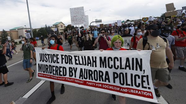 Demonstrators carry a banner while marching down Interstate 225 during a rally and march over the death of 23-year-old Elijah McClain, Saturday, June 27, 2020, in Aurora, Colo. McClain died in late August 2019 after he was stopped while walking to his apartment by three Aurora Police Department officers. - Sputnik International