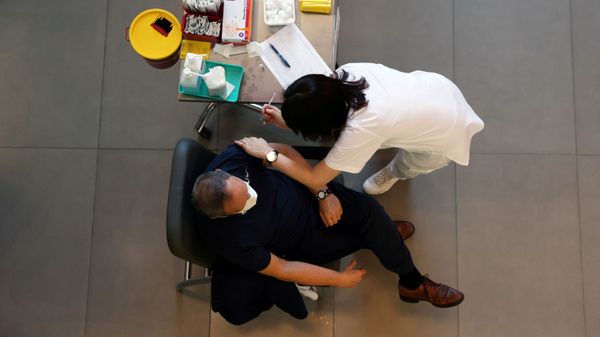 A medical worker vaccinates a man against the coronavirus disease (COVID-19) as Israel kicks off a coronavirus vaccination drive, at Tel Aviv Sourasky Medical Center (Ichilov Hospital) in Tel Aviv, Israel December 20, 2020 - Sputnik International
