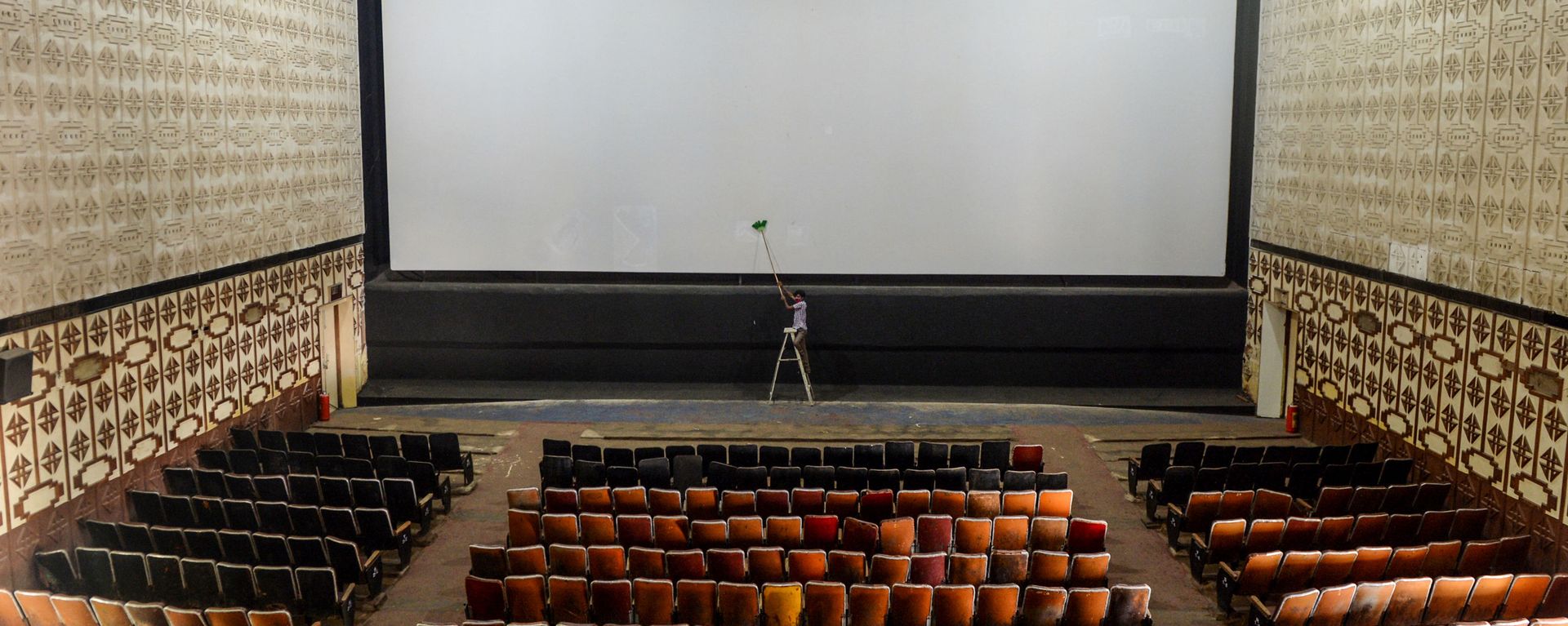 A worker cleans the screen of a cinema hall as part of preparations for a possible reopening after the government eased the lockdown restrictions previously imposed due to the Covid-19 coronavirus, in Chennai on October 8, 2020 A worker cleans the screen of a cinema hall as part of preparations for a possible reopening after the government eased the lockdown restrictions previously imposed due to the Covid-19 coronavirus, in Chennai on October 8, 2020 - Sputnik International, 1920, 29.08.2021