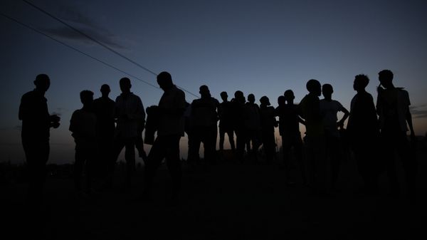 Tigrayan refugees who fled the conflict in the Ethiopia's Tigray gather after the sun sets in Hamdayet, eastern Sudan, near the border with Ethiopia, on March 23, 2021. For months, it has been the Tigrayans' word against that of the government in Ethiopia, Africa's second most populous country and one of its most powerful. But now, for the first time, there is official proof of what is being called ethnic cleansing in the form of identity cards smuggled across the border into this Sudanese border post and confirmed to The Associated Press by more than a half-dozen refugees from different communities. (AP Photo/Nariman El-Mofty) - Sputnik International