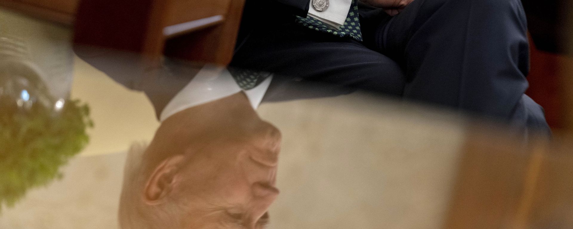 President Joe Biden, seen in reflection, sits next to a bowl of Irish shamrocks, left, as he has a virtual meeting with Ireland's Prime Minister Micheal Martin on St. Patrick's Day, in the Oval Office of the White House, Wednesday, March 17, 2021, in Washington. President Joe Biden, seen in reflection, sits next to a bowl of Irish shamrocks, left, as he has a virtual meeting with Ireland's Prime Minister Micheal Martin on St. Patrick's Day, in the Oval Office of the White House, Wednesday, March 17, 2021, in Washington. - Sputnik International, 1920, 12.02.2022