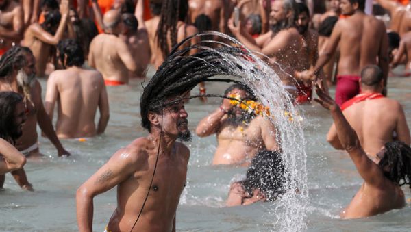 Naga Sadhus, or Hindu holy men, take a dip in the Ganges river during the first Shahi Snan at Kumbh Mela, or the Pitcher Festival, in Haridwar, India, March 11, 2021 - Sputnik International
