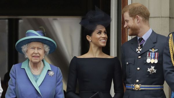 In this Tuesday, July 10, 2018 file photo Britain's Queen Elizabeth II, and Meghan the Duchess of Sussex and Prince Harry watch a flypast of Royal Air Force aircraft pass over Buckingham Palace in London. - Sputnik International