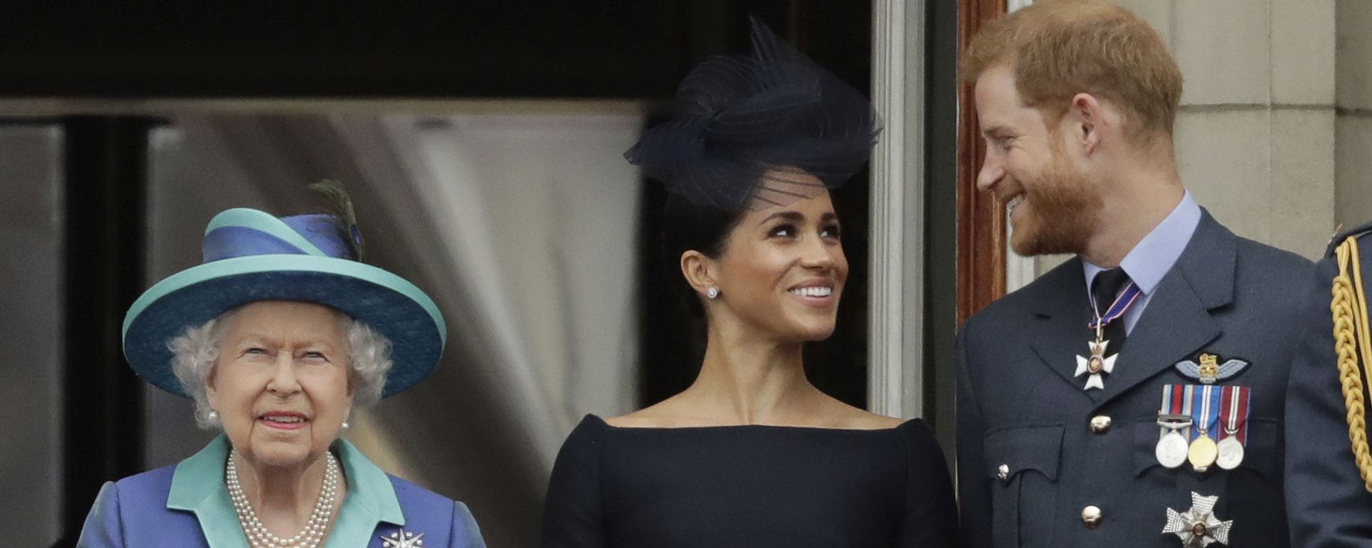 In this Tuesday, July 10, 2018 file photo Britain's Queen Elizabeth II, and Meghan the Duchess of Sussex and Prince Harry watch a flypast of Royal Air Force aircraft pass over Buckingham Palace in London. - Sputnik International, 1920, 14.04.2021