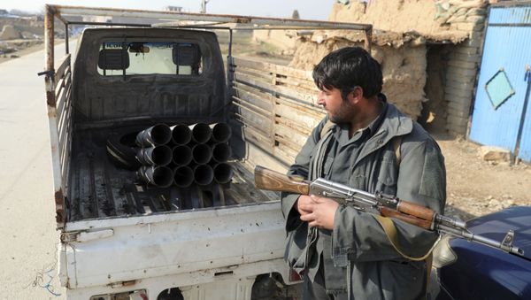 An Afghan security person sand near a vehicle in which rockets were placed, in Bagram, north of Kabul, Afghanistan, Saturday, Dec. 19, 2020. - Sputnik International