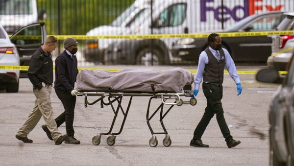 A body is taken from the scene where multiple people were shot at a FedEx Ground facility in Indianapolis, Friday, April 16, 2021. A gunman killed several people and wounded others before taking his own life in a late-night attack at a FedEx facility near the Indianapolis airport, police said. - Sputnik International