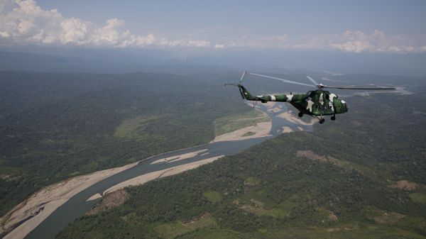 A military helicopter flies over zone where authorities say a group of persons was rescued from a Shining Path rebels camp, in Mazamari, Peru, Wednesday, Aug. 5, 2015. - Sputnik International