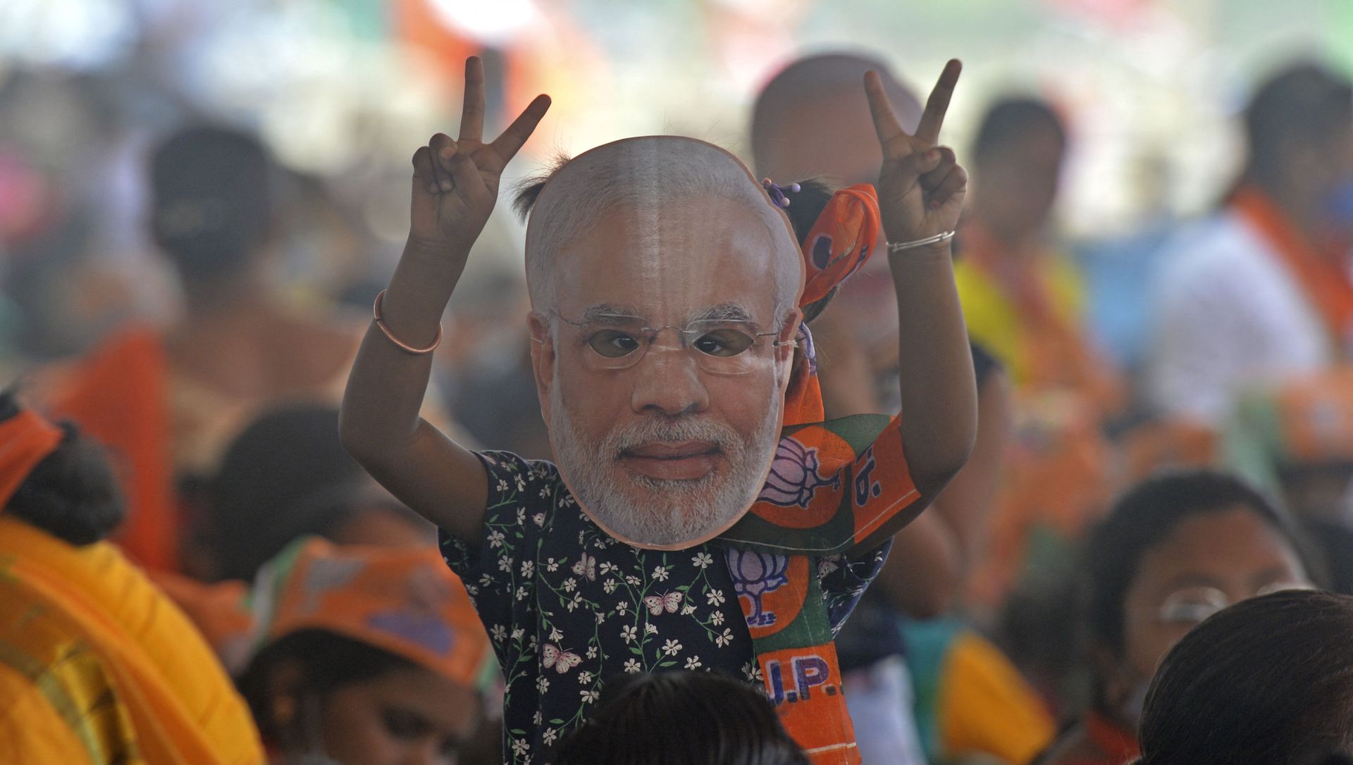 A supporter of Bharatiya Janata Party (BJP) wearing a face cutout of Indian Prime Minister Narendra Modi attends a public rally being addressed by him during the ongoing fourth phase of the West Bengal's state legislative assembly elections, at Kawakhali on the outskirts of Siliguri on April 10, 2021. A supporter of Bharatiya Janata Party (BJP) wearing a face cutout of Indian Prime Minister Narendra Modi attends a public rally being addressed by him during the ongoing fourth phase of the West Bengal's state legislative assembly elections, at Kawakhali on the outskirts of Siliguri on April 10, 2021. - Sputnik International, 1920, 30.05.2021