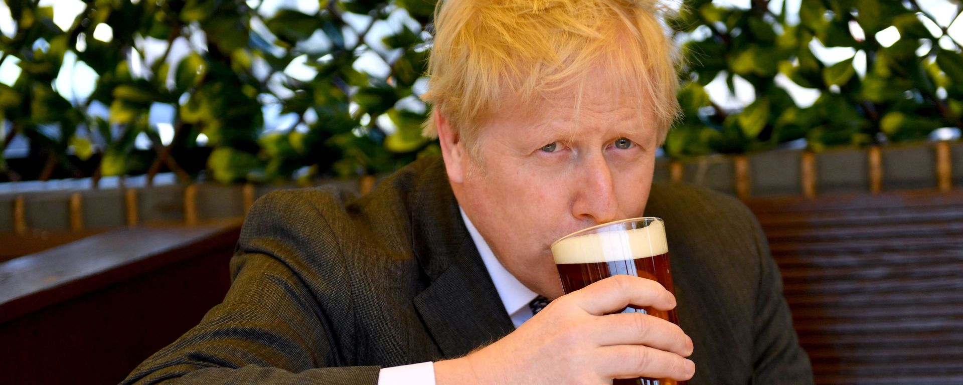 Prime Minister Boris Johnson sips a pint in the beer garden during a visit to The Mount Tavern Pub and Restaurant on the local election campaign trail in Wolverhampton, West Midlands, Britain April 19, 2021. - Sputnik International, 1920, 11.01.2022