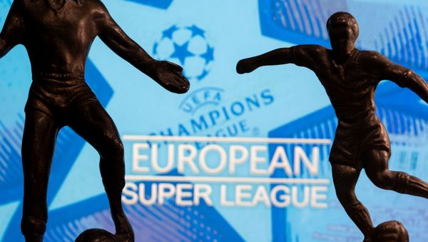 Metal figures of football players are seen in front of the words European Super League and the UEFA Champions League logo in this illustration taken April 20, 2021. Metal figures of football players are seen in front of the words European Super League and the UEFA Champions League logo in this illustration taken April 20, 2021. - Sputnik International