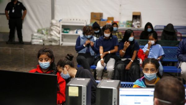 Young migrants get processed at the intake area of the Donna Department of Homeland Security holding facility, the main detention centre for unaccompanied children in the Rio Grande Valley, in Donna, Texas, Tuesday, March 30, 2021.  - Sputnik International
