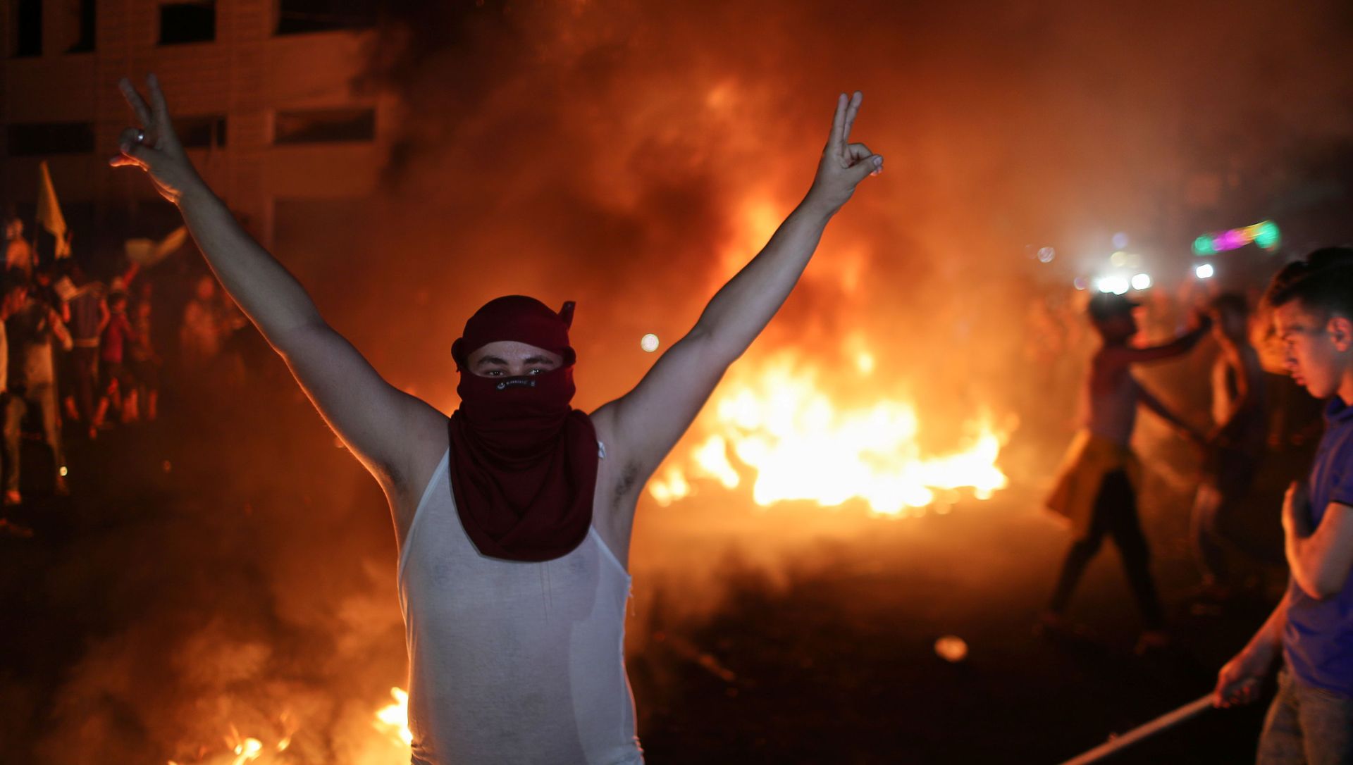 A Palestinian demonstrator gestures as tires burn during an anti-Israel protest over tension in Jerusalem, in Gaza City April 24, 2021. A Palestinian demonstrator gestures as tires burn during an anti-Israel protest over tension in Jerusalem, in Gaza City April 24, 2021. - Sputnik International, 1920, 25.04.2021