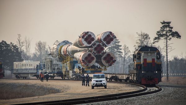 A Soyuz-2.1b rocket booster with a Fregat upper stage and satellites of British firm OneWeb is transported from a technical facility to a launch pad at the Vostochny Cosmodrome in Amur Region, Russia April 22, 2021. - Sputnik International