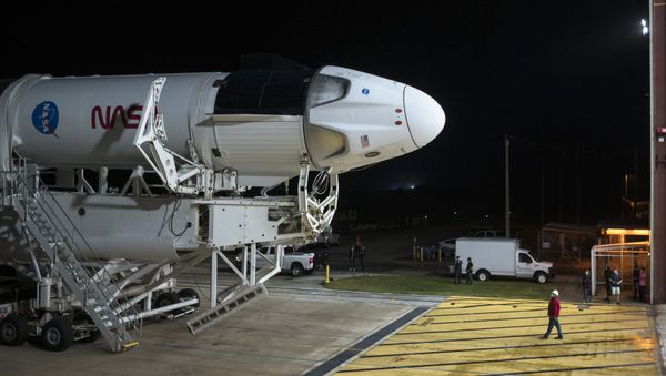 In this Monday, Nov. 9, 2020 photo provided by NASA, a SpaceX Falcon 9 rocket and Crew Dragon capsule is rolled out of the horizontal integration facility at Launch Complex 39A, as preparations continue for a crewed mission at NASA's Kennedy Space Center in Florida.  - Sputnik International