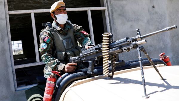 An Afghan National Army soldier sits on a back of an army vehicle at a checkpoint on the outskirts of Kabul, Afghanistan April 21, 2021. - Sputnik International