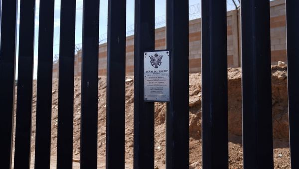 A plaque for former U.S. President Donald Trump is seen at the U.S. border wall in Calexico, California, U.S., April 8, 2021. - Sputnik International
