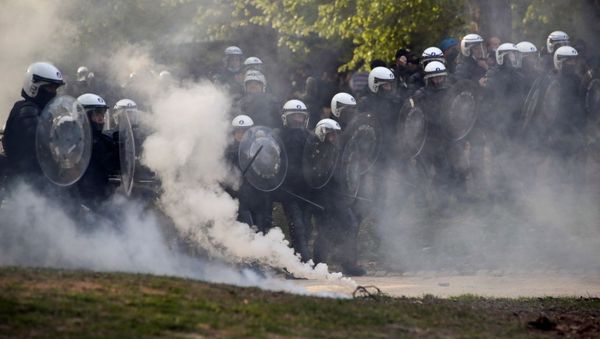 Police officers carry shields during clashes as people gather at the Bois de la Cambre/Ter Kamerenbos park for a party called La Boum 2 in defiance of Belgium's coronavirus disease (COVID-19) social distancing measures and restrictions, in Brussels, Belgium May 1, 2021. - Sputnik International