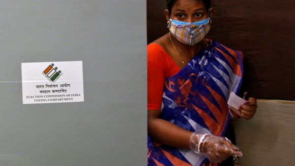 A woman wearing a protective face mask leaves after casting her vote at a polling station during the seventh phase of West Bengal state election, amidst the spread of the coronavirus disease (COVID-19), in Kolkata, India - Sputnik International