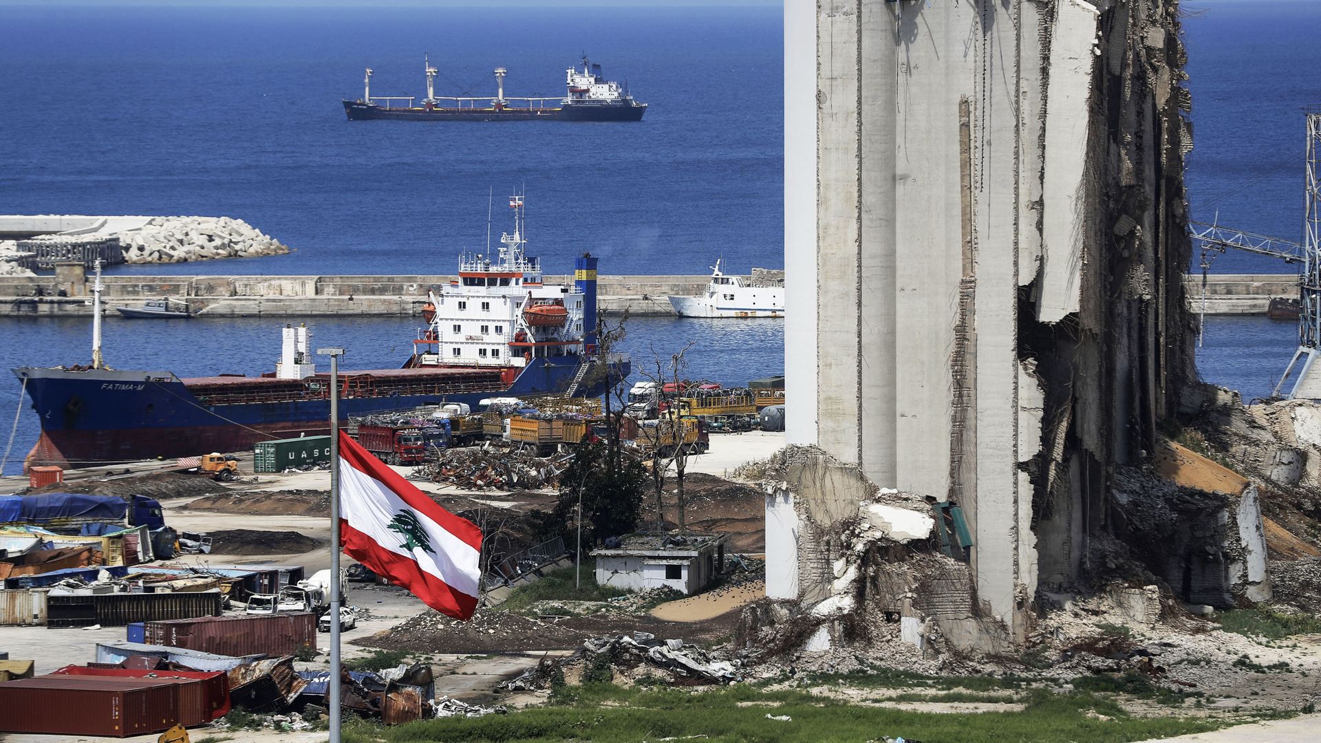 A picture shows a view of the damaged grain silos at the port of the Lebanese capital Beirut, on April 9, 2021, still reeling from the destruction due to a catastrophic blast in a harbour storage unit last August that killed more than 200 people and damaged swathes of the capital, with the Togo-flagged Fatima M bulk carrier ship moored nearby.  - Sputnik International, 1920, 05.05.2021