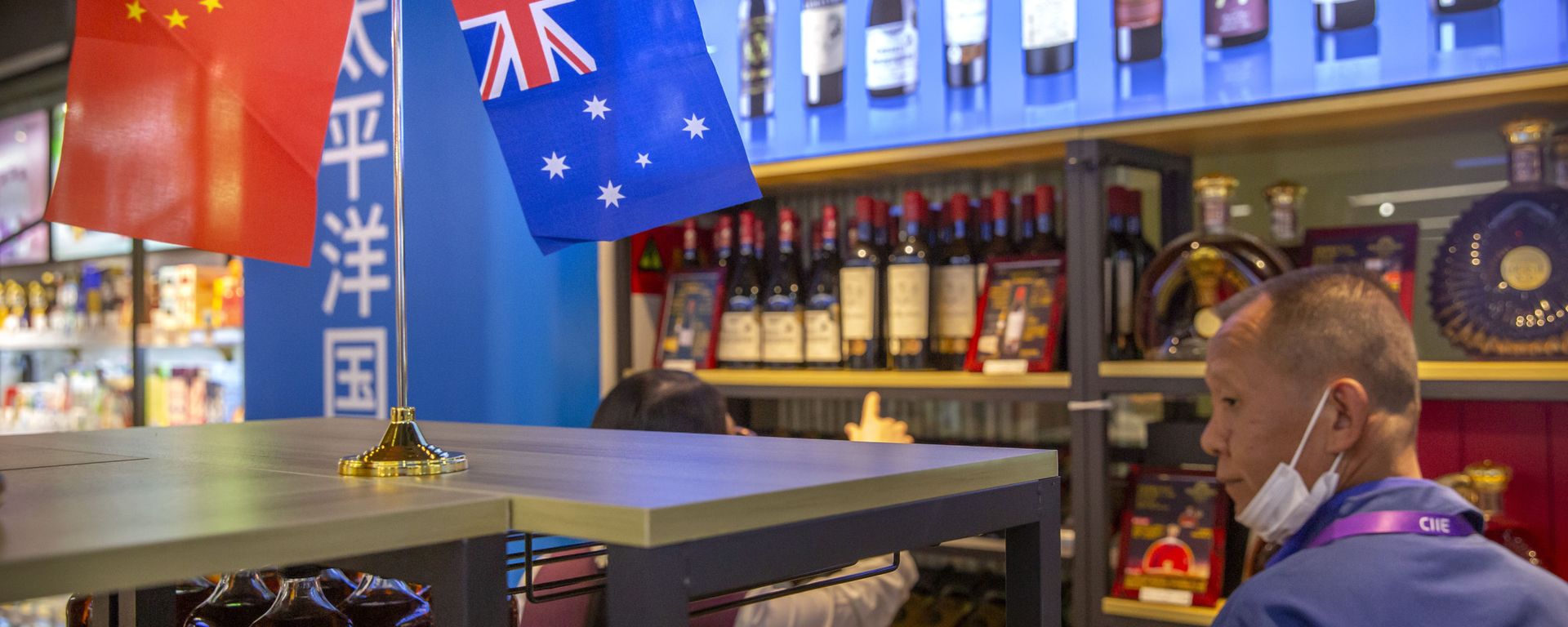 A visitor wearing a face mask to protect against the coronavirus looks at a display of Australian wines at the China International Import Expo (CIIE) in Shanghai on Nov. 5, 2020. China is raising import taxes on Australian wine, stepping up pressure on Australia over disputes including its support for a probe into the origin of the coronavirus. A visitor wearing a face mask to protect against the coronavirus looks at a display of Australian wines at the China International Import Expo (CIIE) in Shanghai on Nov. 5, 2020. China is raising import taxes on Australian wine, stepping up pressure on Australia over disputes including its support for a probe into the origin of the coronavirus. - Sputnik International, 1920, 26.10.2022