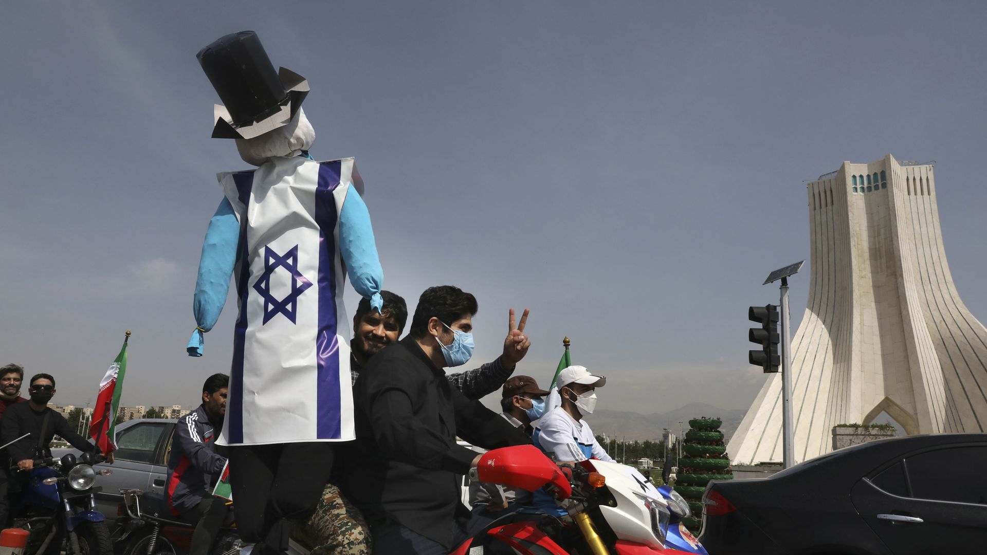 A demonstrator on a motorcycle holds an effigy representing Israel and the United States during the annual Al-Quds, or Jerusalem, Day rally, with the Azadi (Freedom) monument tower seen at right, in Tehran, Iran, Friday, 7 May 2021. A demonstrator on a motorcycle holds an effigy representing Israel and the United States during the annual Al-Quds, or Jerusalem, Day rally, with the Azadi (Freedom) monument tower seen at right, in Tehran, Iran, Friday, 7 May 2021. - Sputnik International, 1920, 07.05.2021