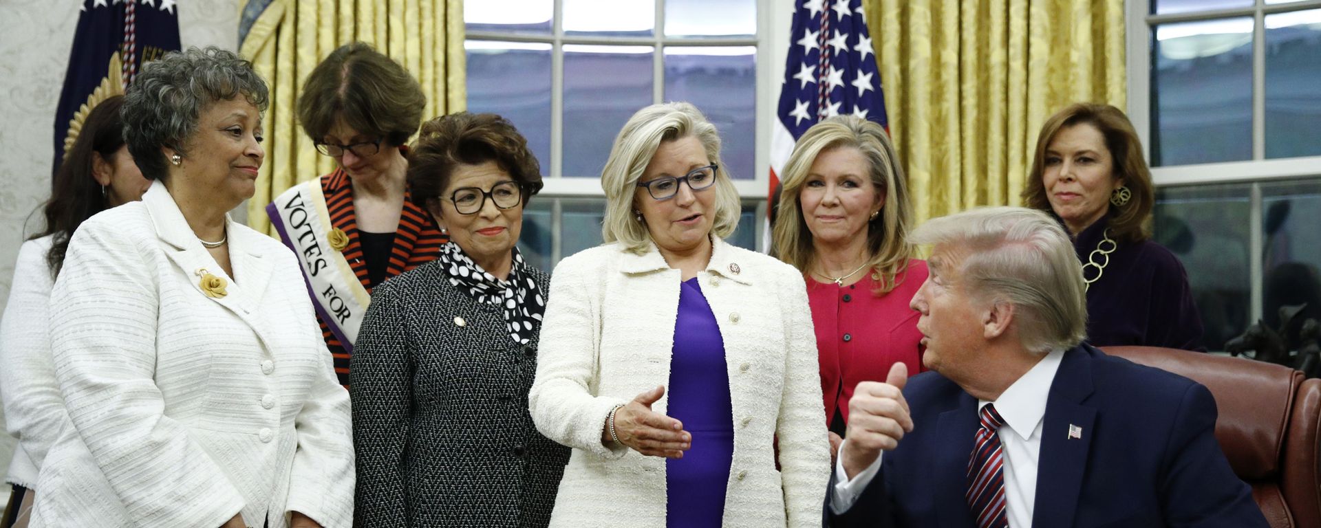 Rep. Liz Cheney, R-Wyo., center, speaks with President Donald Trump during a bill signing ceremony for the Women's Suffrage Centennial Commemorative Coin Act in the Oval Office of the White House, Monday, Nov. 25, 2019, in Washington. Rep. Liz Cheney, R-Wyo., center, speaks with President Donald Trump during a bill signing ceremony for the Women's Suffrage Centennial Commemorative Coin Act in the Oval Office of the White House, Monday, Nov. 25, 2019, in Washington. - Sputnik International, 1920, 04.12.2023