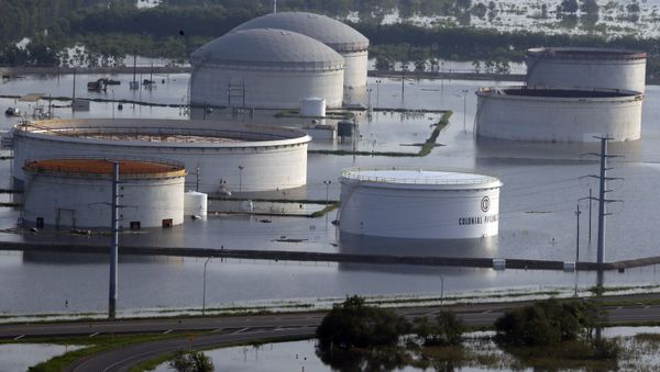 In this aerial photo, holding tanks for Colonial Pipeline Company sit in floodwaters caused Tropical Storm Harvey in Port Arthur, Texas, Friday, Sept. 1, 2017. - Sputnik International