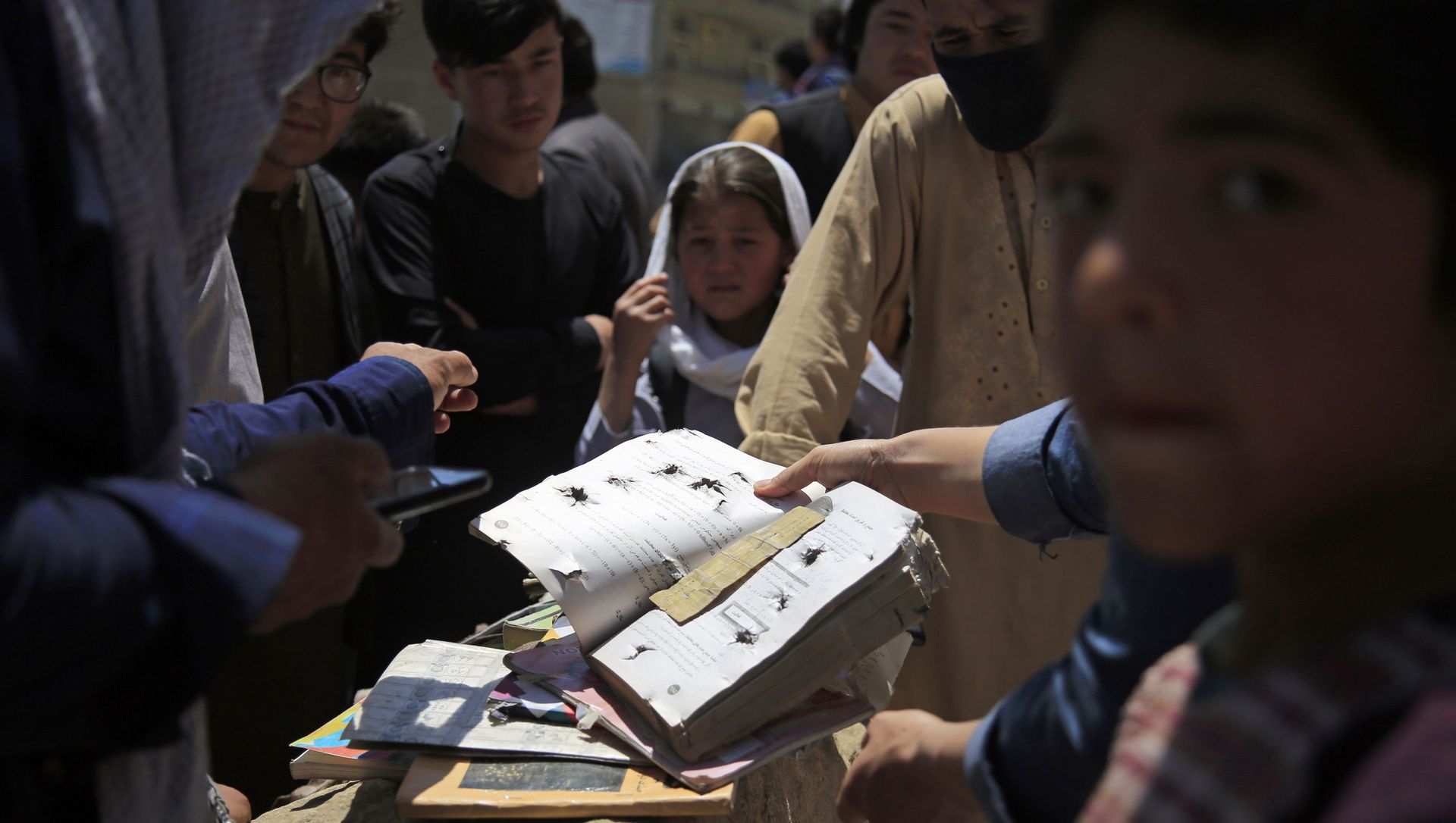 Afghans go through belongings left behind after deadly bombings on Saturday near a school in Kabul, Afghanistan, Sunday, May 9, 2021. Afghans go through belongings left behind after deadly bombings on Saturday near a school in Kabul, Afghanistan, Sunday, May 9, 2021. - Sputnik International, 1920, 09.05.2021