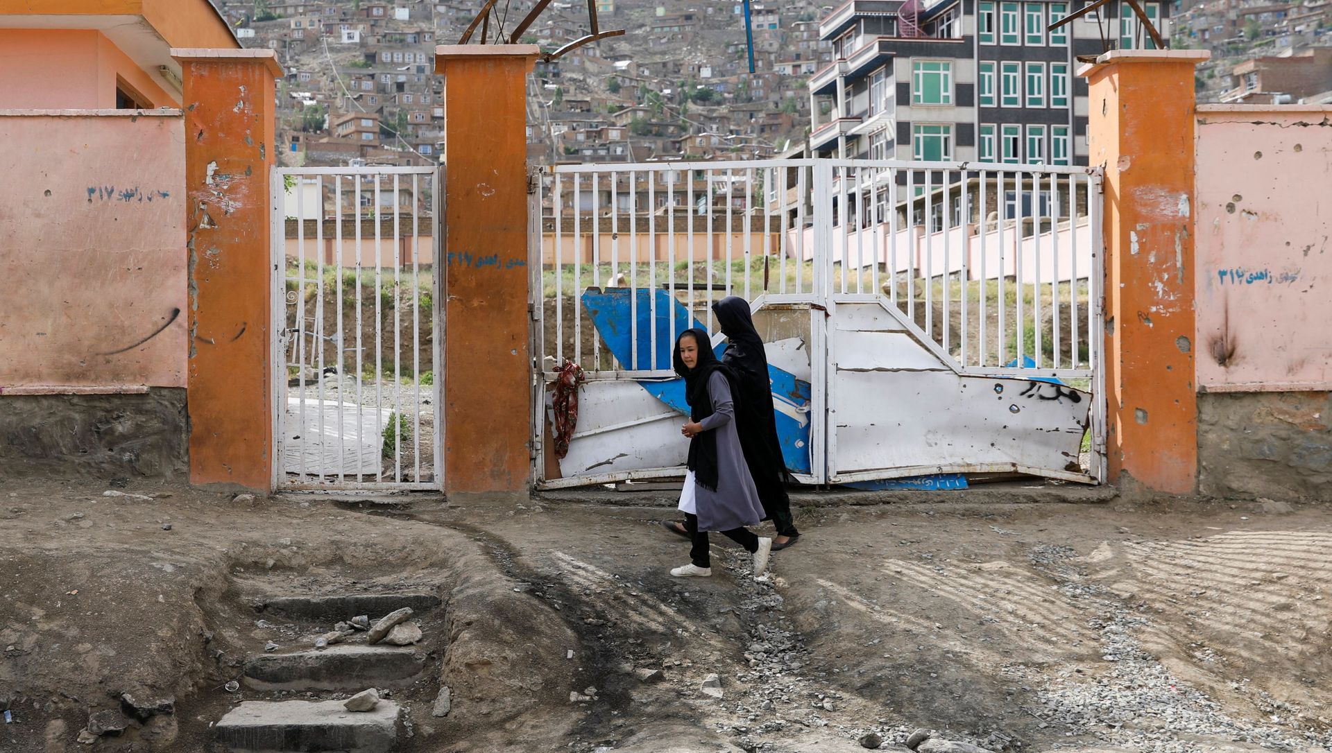 A woman with a girl walks past the site of a car bomb blast that targeted schoolgirls in Kabul, Afghanistan May 10, 2021. A woman with a girl walks past the site of a car bomb blast that targeted schoolgirls in Kabul, Afghanistan May 10, 2021. - Sputnik International, 1920, 10.05.2021