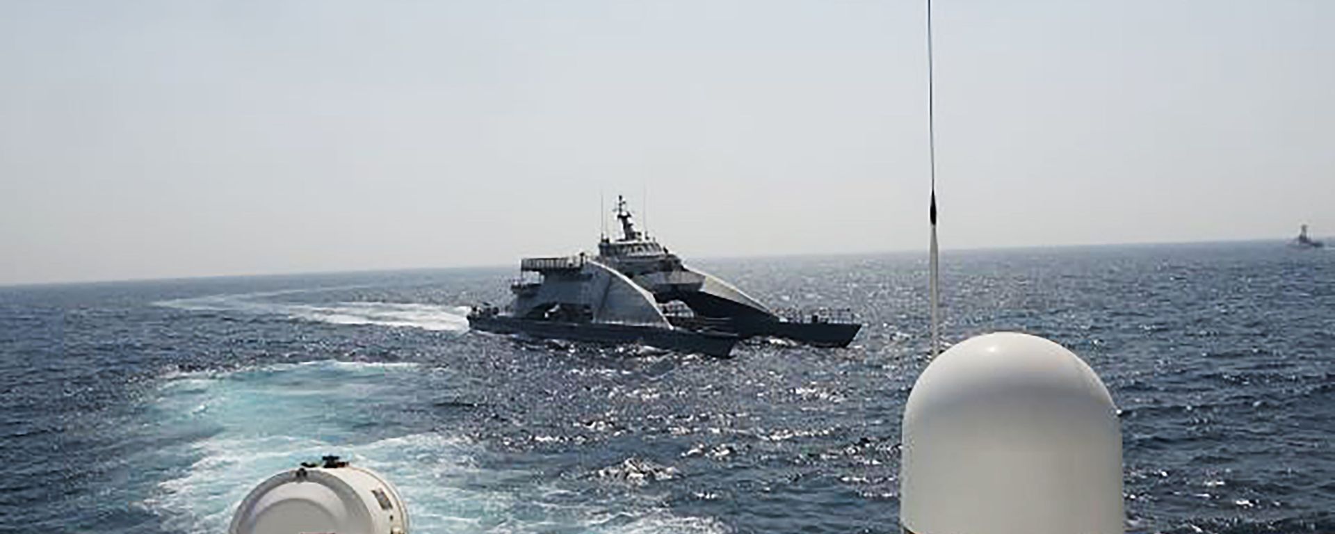 In an April 2, 2021, photo released by the U.S. Navy, an Iranian Revolutionary Guard vessel cuts in front of the U.S. Coast Guard ship USCGC Wrangell in the Persian Gulf In an April 2, 2021, photo released by the U.S. Navy, an Iranian Revolutionary Guard vessel cuts in front of the U.S. Coast Guard ship USCGC Wrangell in the Persian Gulf - Sputnik International, 1920, 10.05.2021