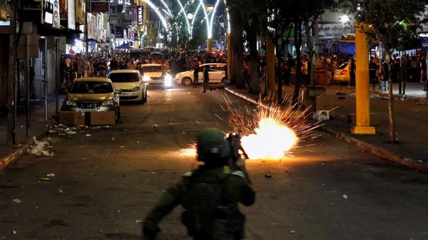 A stun grenade fired by Israeli forces explodes as Palestinians take part in an anti-Israel protest amid a flare-up of Israeli-Palestinian violence, in Hebron in the Israeli-occupied West Bank May 11, 2021. - Sputnik International