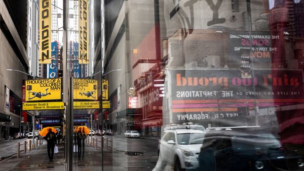 FILE PHOTO: A man walks outside the shuttered John Golden Theatre amid coronavirus disease (COVID-19) pandemic in New York City, U.S., April 12, 2021.  - Sputnik International