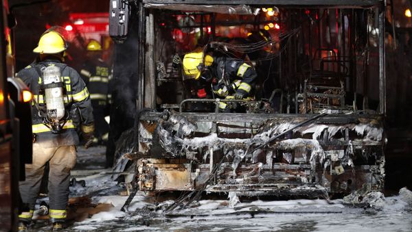 Israeli firefighters check out a burnt bus in the Israeli town of Holon near Tel Aviv, on May 11, 2021, after rockets are launched towards Israel from the Gaza Strip controlled by the Palestinian Hamas movement - Sputnik International