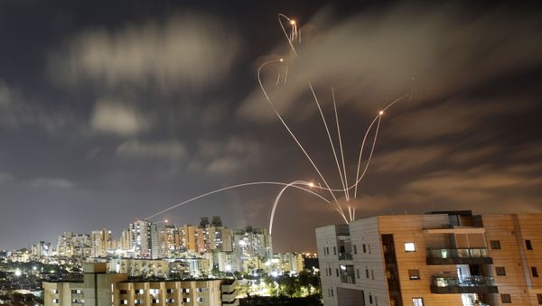 Streaks of light are seen as Israel's Iron Dome anti-missile system intercepts rockets launched from the Gaza Strip towards Israel, as seen from Ashkelon, Israel May 12, 2021. - Sputnik International