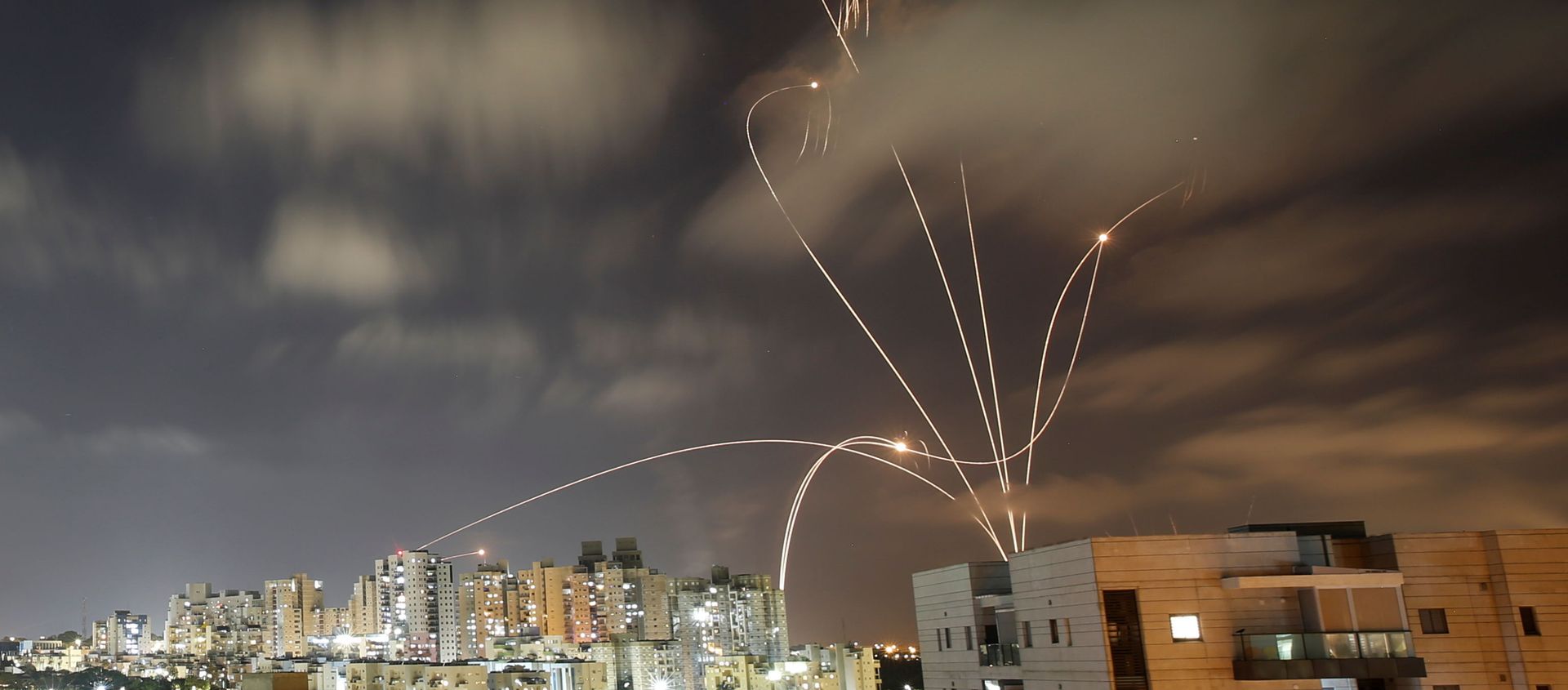 Streaks of light are seen as Israel's Iron Dome anti-missile system intercepts rockets launched from the Gaza Strip towards Israel, as seen from Ashkelon, Israel May 12, 2021. Streaks of light are seen as Israel's Iron Dome anti-missile system intercepts rockets launched from the Gaza Strip towards Israel, as seen from Ashkelon, Israel May 12, 2021. - Sputnik International, 1920, 12.05.2021