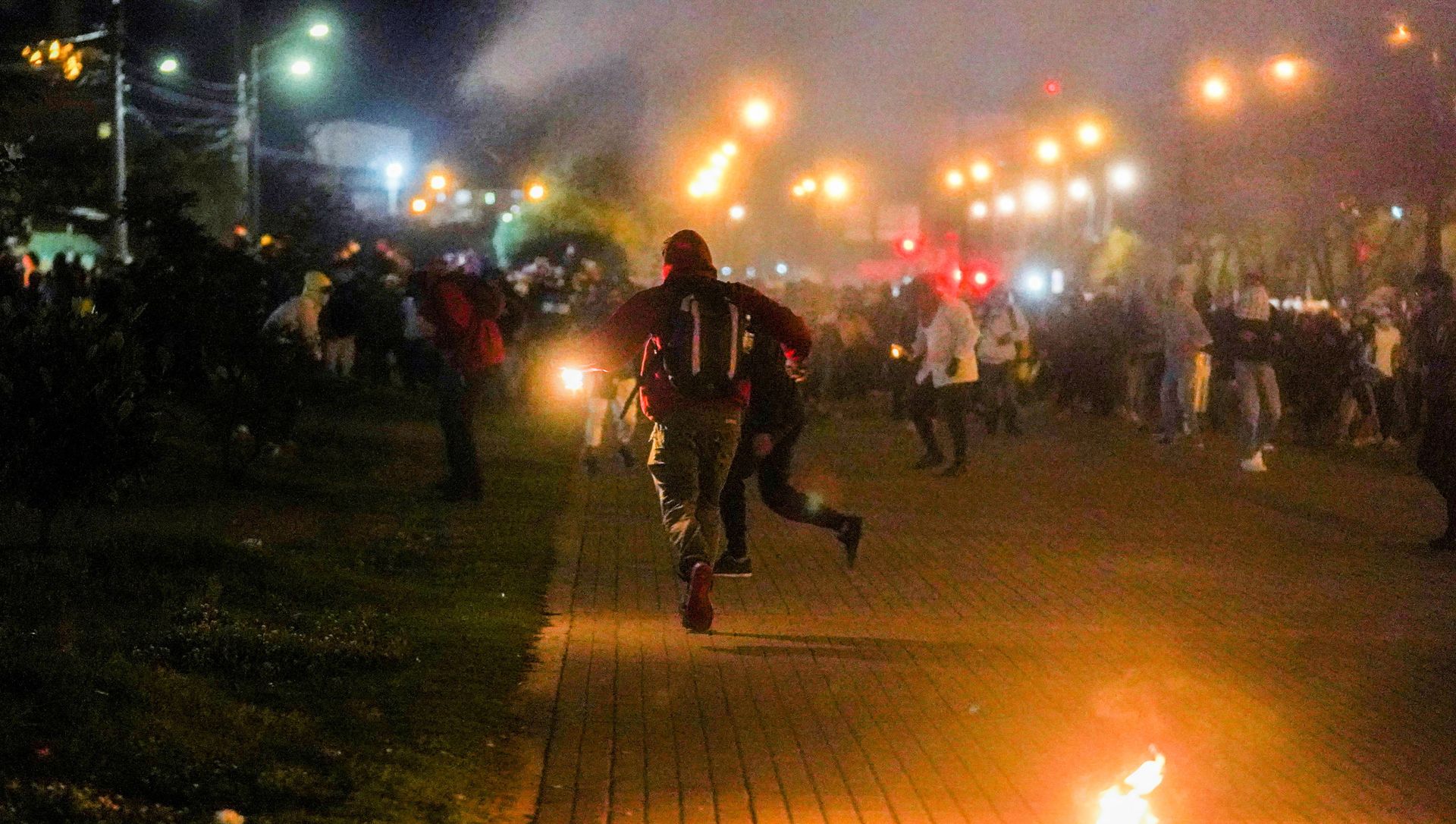 Demonstrators run while tear gas falls during a protest demanding government action to tackle poverty, police violence and inequalities in healthcare and education systems, in Bogota, Colombia, May 10, 2021. Demonstrators run while tear gas falls during a protest demanding government action to tackle poverty, police violence and inequalities in healthcare and education systems, in Bogota, Colombia, May 10, 2021. - Sputnik International, 1920, 13.05.2021