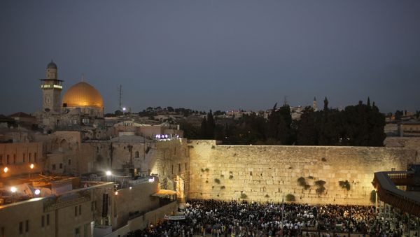 Jewish worshippers welcome the Shabbat, Hebrew for Sabbath, a day of religious observance and abstinence from work, kept by Jews from Friday evening to Saturday evening, by praying at the Western wall, the holiest site where Jews can pray, on October 14, 2016 in Jerusalem's Old City. - Israel suspended cooperation with UNESCO after the UN cultural organisation adopted two resolutions on the occupied Palestinian territories including annexed east Jerusalem ahead of a final vote next week. The resolutions refer to the Al-Aqsa mosque compound (background) in east Jerusalem's Old City -- Islam's third holiest site -- without any reference to the site also being revered by Jews as the Temple Mount. - Sputnik International