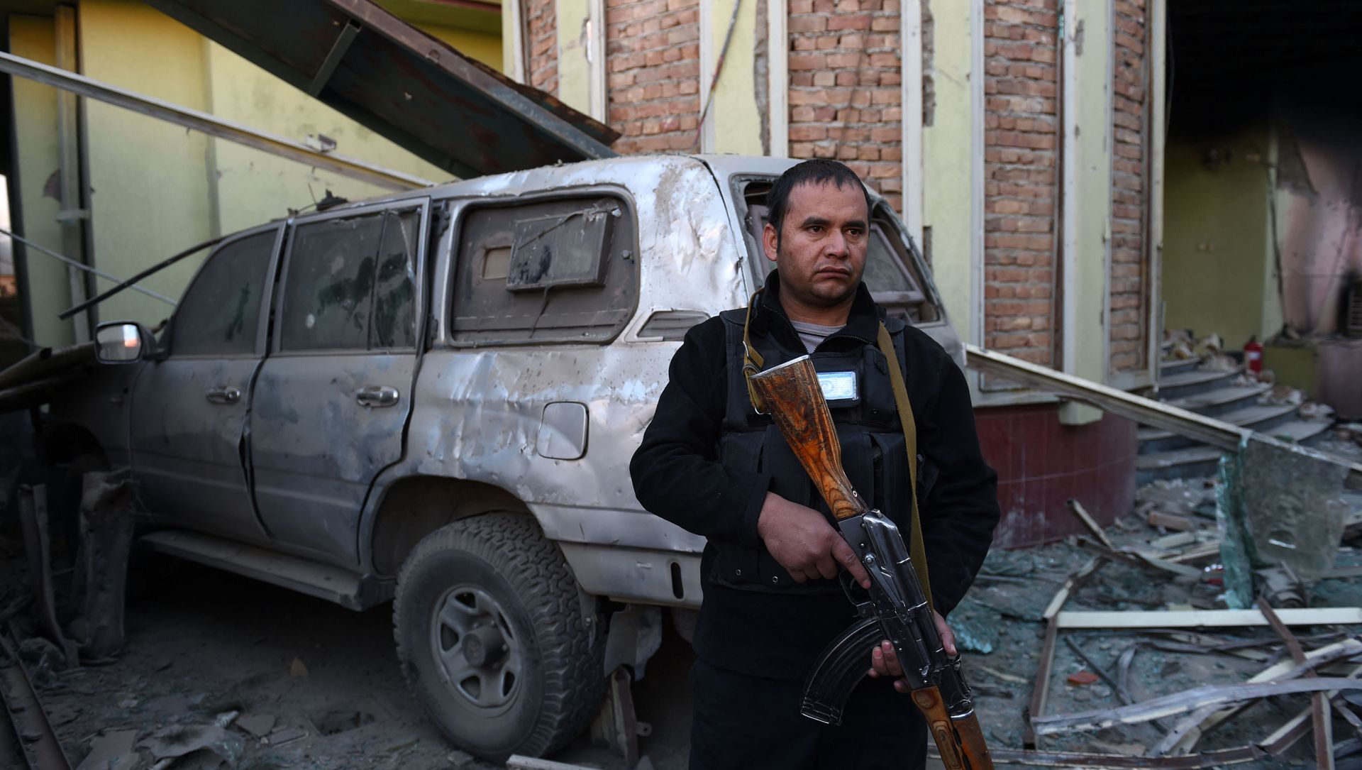 An Afghan security official stands alert among damaged buildings and a vehicle after a car bomb attack near the Spanish embassy compound in Kabul on December 12, 2015 An Afghan security official stands alert among damaged buildings and a vehicle after a car bomb attack near the Spanish embassy compound in Kabul on December 12, 2015 - Sputnik International, 1920, 13.05.2021