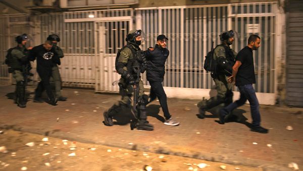 Israeli forces detain a group of Arab-Israelis in the mixed Jewish-Arab city of Lod on May 13, 2021, during clashes between Israeli far-right extremists and Arab-Israelis. - Sputnik International