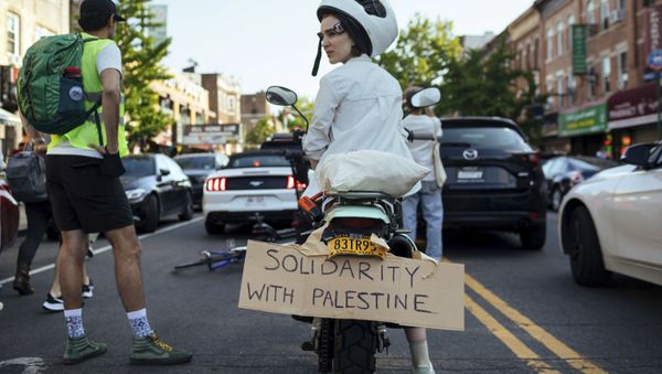 An Activist sits on her scooter as thousands of activists supporting Palestine converge in Brooklyn Saturday, May 15, 2021, in New York. - Sputnik International